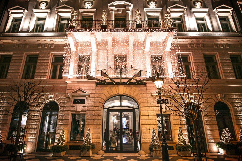 Grand hotel building with a symmetrical facade on a quiet Budapest street