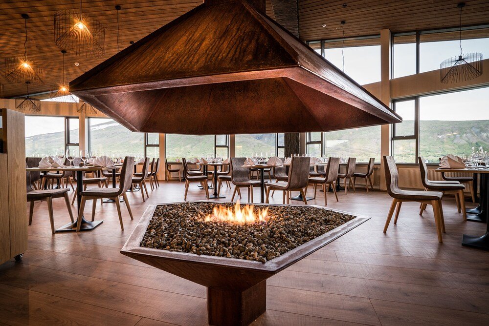 Restaurant dining room with a central fire feature