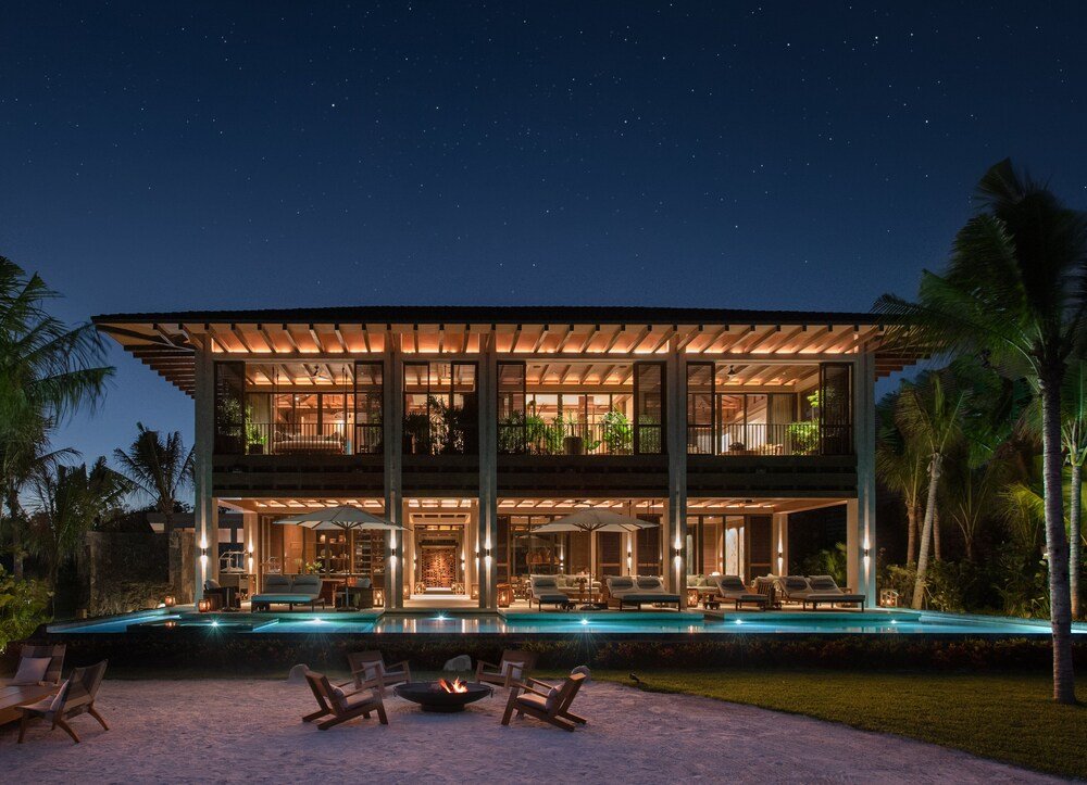 Modern two-story house with a swimming pool and outdoor seating